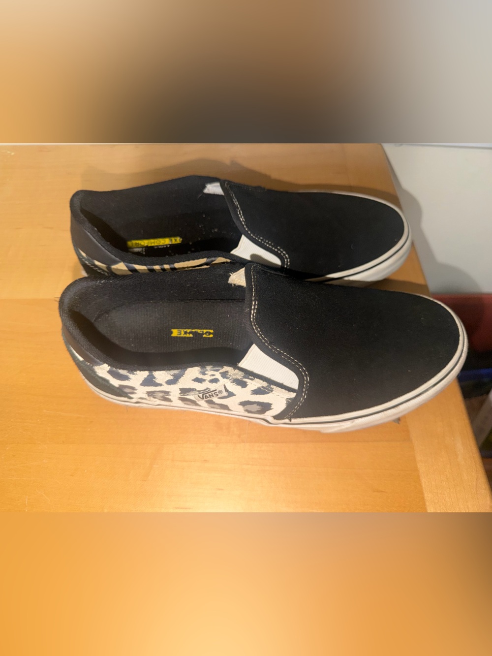 Vans Slip-On Sneakers in Black with White Leopard Panels